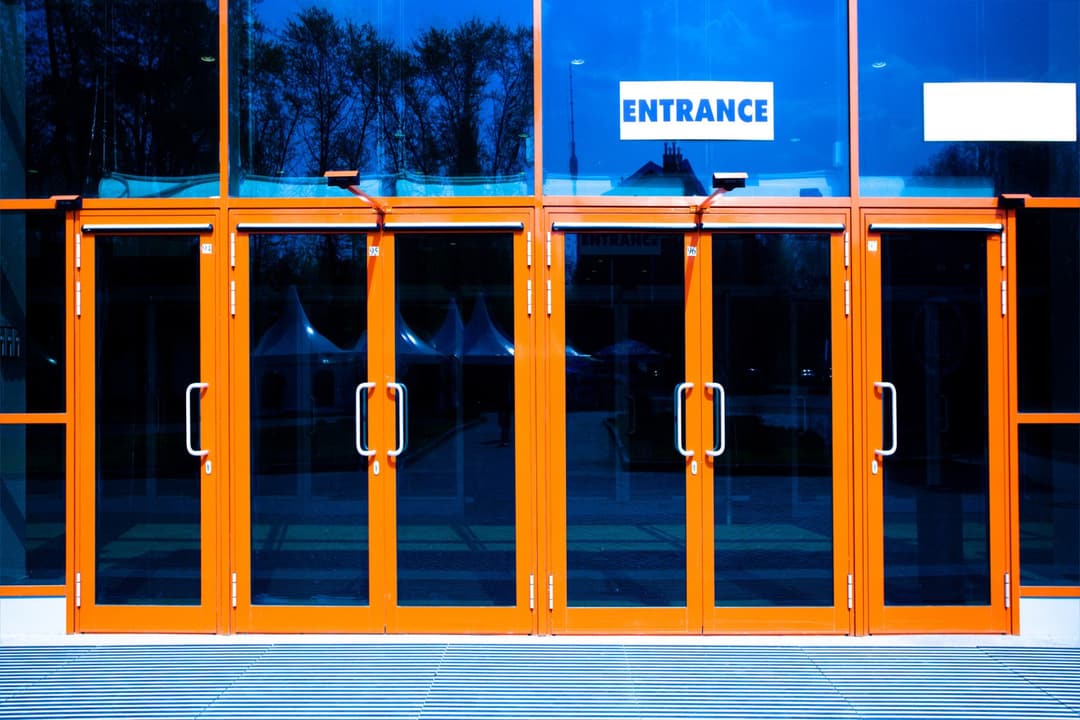 Commercial entrance with orange aluminium-framed doors