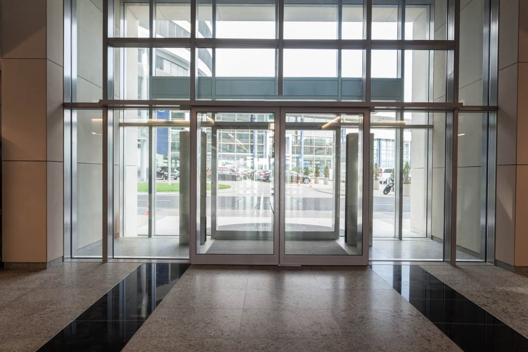 Glazed automatic entrance doors at a commercial building